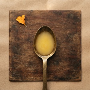 A brass spoon of golden cow ghee